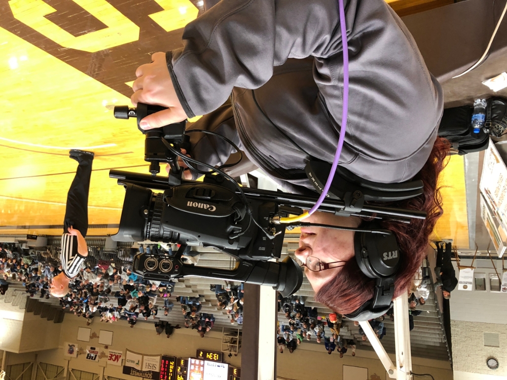 Laura H. operates a court side camera in the RA facility
